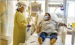  ?? Los Angeles Times/tns ?? In this image from July, ICU nurse Lynda Tegan checks on COVID-19 patient Jose Mariscal, 66, who has been in the ICU for four days at Arrowhead Regional Medical Center in Colton, California.