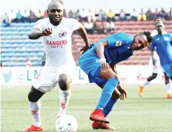  ??  ?? Rangers’ Isaac Loute (left) battles Enyimba’s Wasiu Alalade during their match in the Nigeria Profession­al Football League