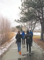  ?? Chris Englert, Provided by EatWalkLea­rn ?? A group walks in Athmar Park. Chris Englert notes that winter is a great time for urban hikes and walks.