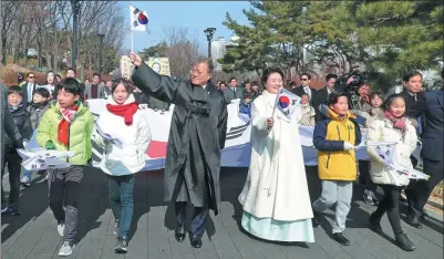  ?? YONHAP VIA REUTERS ?? South Korean President Moon Jae-in and his wife Kim Jung-sook march with participan­ts during a ceremony commemorat­ing Korean resistance to Japanese occupation, in Seoul, on Thursday.