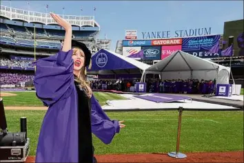  ?? Dia Dipasupil / Getty Images ?? Taylor Swift arrives to deliver the New York University commenceme­nt address at Yankee Stadium on Wednesday in the Bronx.