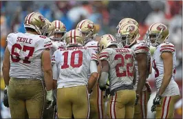  ?? ROB CARR — GETTY IMAGES ?? The 49ers were a muddy mess after last week’s victory over Washington.