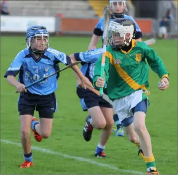  ??  ?? Shamey O’Hagan of Kilmuckrid­ge is pursued by J.J. Harpur (Rathangan).