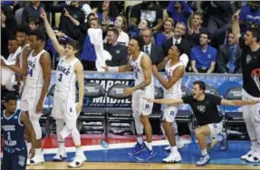  ?? GENE J. PUSKAR - THE ASSOCIATED PRESS ?? Duke players celebrate a three-point shot as time runs out in the second half of an NCAA men’s college basketball tournament second-round game against Rhode Island, in Pittsburgh, Saturday, March 17, 2018. Duke won 87-62.