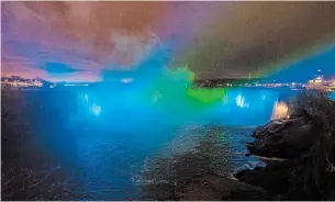  ?? JULIE JOCSAK TORSTAR ?? The lights on Niagara Falls were changed to blue and green at the top of every hour on Wednesday evening to honour to Six Nations businessma­n Ken Hill, who died Monday.