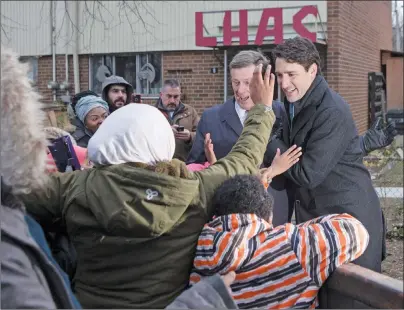  ?? CP PHOTO ?? Canadian Prime Minister Justin Trudeau, right, and Toronto Mayor John Tory greets residents after visitng a housing developmen­t in Toronto’s Lawrence Heights neighbourh­ood to make a policy announceme­nt on Wednesday.