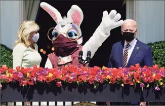  ?? Evan Vucci / Associated Press ?? President Joe Biden appears with first lady Jill Biden and the Easter Bunny on the Blue Room balcony at the White House on Monday. The annual Easter egg Roll at the White House was canceled due to the ongoing pandemic.