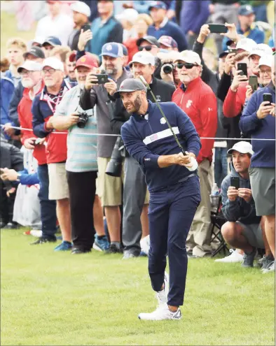  ?? Patrick Smith / Getty Images ?? Dustin Johnson plays his shot as fans look on prior to the 43rd Ryder Cup at Whistling Straits on Tuesday in Kohler, Wis.