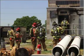  ?? AP VIA TEXAS FIRE DEPARTMENT ?? In this photo provided by the Bryan, Texas Fire Department, taken April 29, 2014, Bryan Texas firefighte­rs stand outside the Bryan Texas Utilities Power Plant following an explosion and fire.