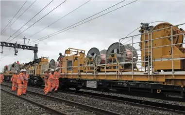  ?? NETWORK RAIL. ?? Network Rail engineers install wiring at Brinkworth (west of Swindon) in September, as part of the Great Western modernisat­ion programme. Chris Baker fears that cancellati­on of electrific­ation schemes will have a knock-on effect in years to come, with...