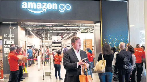  ?? MARK LENNIHAN THE ASSOCIATED PRESS FILE PHOTO ?? Amazon’s unveiling of the first Amazon Go store inspired challenger­s to create new ways for shoppers to grab items and leave without passing through a checkout line.