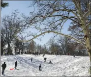  ?? (AP/The Buffalo News/Libby March) ?? Families enjoy sledding , taking advantage of two days of lake-effect snow Sunday at Delaware Park in Buffalo, N.Y.