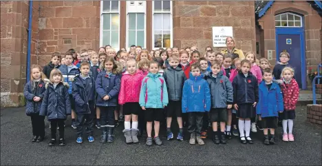  ??  ?? The whole school attended the rededicati­on and remembranc­e ceremony.
01_B46BPS02; and, above, the First World War memorial plaque honouring the Brodick primary pupils who perished during the war now has pride of place at the entrance to the school. 01_B46BPS01