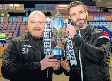  ??  ?? Safe hands: Co-bosses Steven Ferguson, left, and Stuart Kettlewell with the IRN-BRU Cup in March. The former County players led the club to a trophy double after also winning the Championsh­ip title