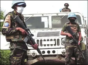  ?? ASSOCIATED PRESS ?? In this image taken from video, United Nations peacekeepe­rs guard the area where a UN convoy was attacked and the Italian ambassador to Congo killed, in Nyiragongo, North Kivu province, Congo Monday.