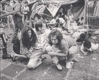  ?? Times Union archive ?? Elpedia Carrillo, James Woods and James Belushi take cover from a political uprising in "Salvador".