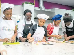  ?? CONTRIBUTE­D ?? Students participat­e in a summer camp cooking activity inside the Nestlé Corporate Kitchen. The students are being helped by the YOCUTA chefs (young culinary talents) in preparing a quick and easy meal of their choice to encourage healthy eating habits.