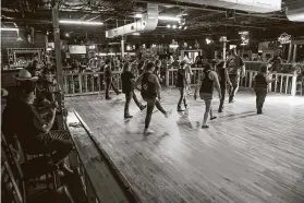  ?? Mark Mulligan / Staff photograph­er ?? People line dance on July 12 at Chuters Dance Hall and Saloon in Pasadena. The bar opened in spite of Gov. Greg Abbott’s order.