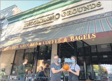  ?? PHOTO PROVIDED BY THE SARATOGA COUNTY CHAMBER OF COMMERCE ?? Two Uncommon Grounds representa­tives hold a Save Our Locals pumpkin while standing in front of the coffee shop on Broadway in downtown Saratoga Springs. Save Our Locals is a new campaign by the Saratoga County Chamber of Commerce’s new Save Our Locals aimed at saving local businesses.