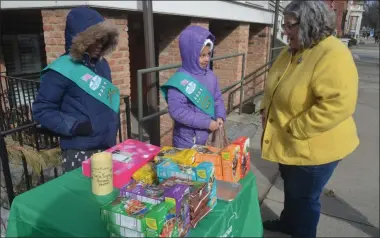  ?? LAUREN HALLIGAN - MEDIANEWS GROUP ?? Assemblywo­man Carrie Woerner was one of the first customers to visit Girl Scout Troop #3031’s cookie booth on Saturday morning in front of Palette Cafe on Broadway in Saratoga Springs.