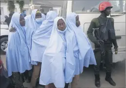  ?? SUNDAY ALAMBA — THE ASSOCIATED PRESS ?? Some of the students who were abducted by gunmen from the Government Girls Secondary School in Jangebe, Nigeria, last week wait for a medical checkup Tuesday after their release in Gusau, Nigeria.