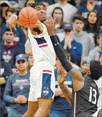  ?? JESSICA HILL/AP PHOTO ?? UConn’s Isaiah Whaley blocks a shot attempt by Cincinnati’s Tre Scott during a game last season at Gampel Pavilion in Storrs. Whaley and the Huskies return to the Big East Conference this winter.