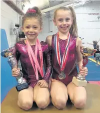  ??  ?? Lily Sewell on the left, and Ava Cummins on the right of Sparks Gymnastics in Heywood