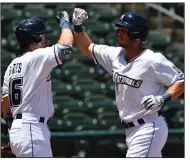  ?? (NWA Democrat-Gazette/Andy Shupe) ?? Northwest Arkansas Naturals first baseman Jake Means (right) is congratula­ted by left fielder Parker Bates after hitting a home run during their 7-3 win over the Frisco RoughRider­s on June 14 at Arvest Ballpark in Springdale. The Naturals will host the Wichita Wind Surge for a six-game series beginning today.