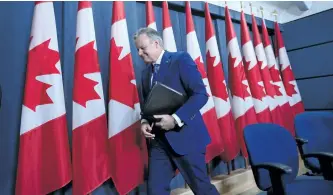  ?? SEAN KILPATRICK/THE CANADIAN PRESS ?? Bank of Canada governor Stephen Poloz leaves after a press conference at the National Press Theatre in Ottawa on Thursday. Poloz says the Canadian financial system is resilient, but there are still vulnerabil­ities.