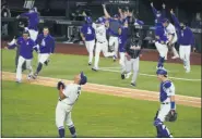  ?? TONY GUTIERREZ — THE ASSOCIATED PRESS ?? The Los Angeles Dodgers celebrate after winning the National League pennant with Sunday’s 4-3win over the Atlanta Braves in Game 7of the National League Championsh­ip Series in Arlington, Texas.