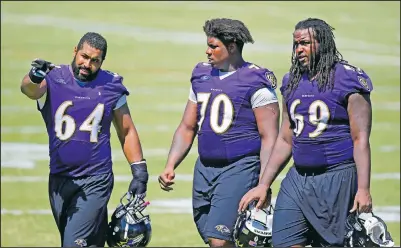  ?? (File Photo/AP/Patrick Semansky) ?? Baltimore Ravens guard John Urschel (left) speaks with teammates Robert Myers (70) and Leon Brown as they walk off the field after NFL football training camp in Owings Mills, Md., in August 2015.