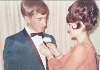  ?? SUBMIITTED ?? Nancy Mueller pins a boutonnièr­e on her now husband, Wally Mueller, for their high school prom. The couple will celebrate their 50th wedding anniversar­y this year. The Fairfield Bay Area Chamber of Commerce will host a Re-Prom Chamber Gala from 6-9 p.m. April 23.