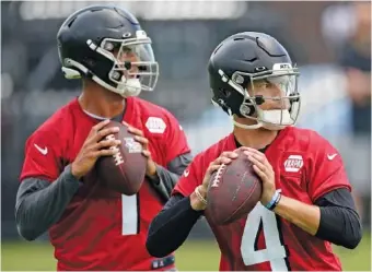  ?? AP PHOTO/JOHN BAZEMORE ?? Atlanta Falcons quarterbac­ks Desmond Ridder (4) and Marcus Mariota work during Tuesday’s minicamp practice in Flowery Branch, Ga. Mariota, the No. 2 overall pick in the 2015 NFL draft, is in his first season with the Falcons after two years with the Las Vegas Raiders but has starting experience with the Tennesssee Titans. Ridder was a third-round draft pick for Atlanta this spring.