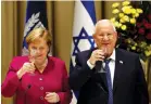  ?? (Amir Cohen/Reuters) ?? GERMAN CHANCELLOR Angela Merkel and President Reuven Rivlin deliver a toast following their meeting yesterday in Jerusalem.