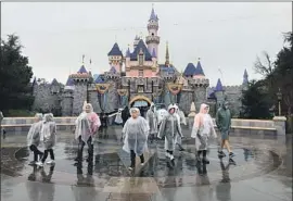  ?? Allen J. Schaben Los Angeles Times ?? CROWDS WERE sparse Thursday at Disneyland amid the rain. More Disney fans f locked to the park Friday for a last hurrah before its closure Saturday.