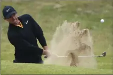  ?? DAVE THOMPSON, THE ASSOCIATED PRESS ?? Northern Ireland’s Rory McIlroy plays out of a bunker on the 18th green Sunday. He finished seven shots behind Jordan Spieth.