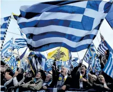  ?? VALERIE GACHE/AFP/GETTY IMAGES ?? People take part in a demonstrat­ion Sunday in Athens to urge the Greek government not to compromise in the festering name row with neighbouri­ng Macedonia over the name of the country.