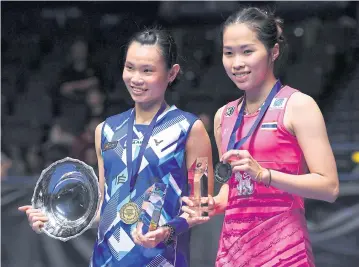  ?? AFP ?? Champion Tai Tzu Ying, left, poses with runner-up Ratchanok Intanon after their match.