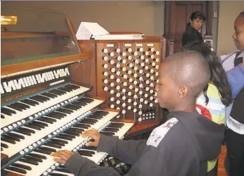  ?? Contribute­d photo ?? A piano student tries the pipe organ during a Pedals, Pipes and Pizza event at the former United Congregati­onal Church in Bridgeport.