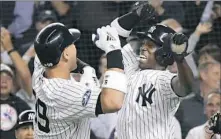  ?? Associated Press ?? Yankees Andrew McCutchen, right, and Aaron Judge celebrate Judge’s two-run home run in the first inning.