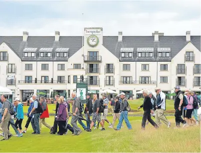  ?? Picture: Getty. ?? Crowds cross the 18th fairway during last year’s Senior Open at Carnoustie Golf Links.