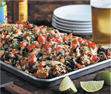  ?? ABEL URIBE/CHICAGO TRIBUNE PHOTOS; SHANNON KINSELLA/FOOD STYLING ?? Roasted cauliflowe­r, beans, tomatoes and tortilla chips with melted cheese — a perfect dish for summer.