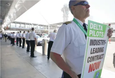  ?? MARIO TAMA/GETTY IMAGES ?? Delta Air Lines pilots protest their union contract on Thursday at Los Angeles Internatio­nal Airport.