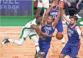  ?? SPORTS
PAUL RUTHERFORD/USA TODAY ?? Celtics guard Kemba Walker (8) passes the ball against Clippers forward Nicolas Batum (33) and center Ivica Zubac (40) at TD Garden.