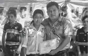  ?? Associated Press file photo ?? Juan de León Gutiérrez poses with his teacher during a school contest in October 2018. Juan died April 30, becoming the third Guatemalan child to die in U.S. custody since December.