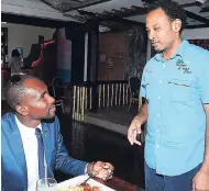  ??  ?? Maurice Harding (left) compliment­s Island Squeez Diner/CruiserZ Lounge’s owner Kevin Pearson on the service after lunch at the location.