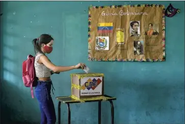  ?? Matias Delacroix Associated Press ?? A VOTER casts her ballot in Caracas, Venezuela. Just 31% voted in the congressio­nal election Sunday. Internatio­nal bodies refused to send observers, saying the conditions for a democratic process don’t exist.