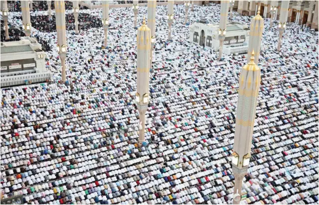  ??  ?? The faithful perform Eid Al-Fitr prayer at the Prophet’s Mosque in Madinah. Over a million Muslims attended the congregati­on. (SPA) Report — Page 2