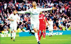  ?? PIERRE-PHILIPPE MARCOU/AFP ?? Real Madrid forward Cristiano Ronaldo celebrates after scoring in their league match with Sevilla at the Santiago Bernabeu stadium on Saturday.
