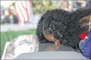  ?? MIAMI HERALD ?? Myeshia Johnson kisses the casket of her husband, Sgt. La David Johnson, during his burial service Saturday. She said the president, at one point, could not remember her husband’s name during a condolence call.